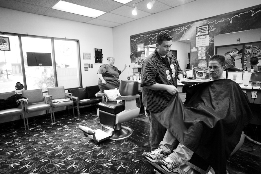 Owners Cassandra Reade and brother Talon Wood wrap up a haircut for Jim Hagler,
a customer of the Junction City Barber Shop for 6 years. Much like many small
shops in JC (including the recently closed Gibson Motor Company), this one
has been passed down from generation to generation.