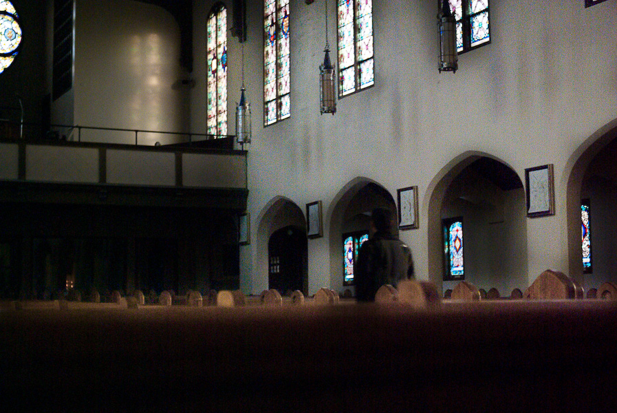 Fr. Maro walks through an empty church.